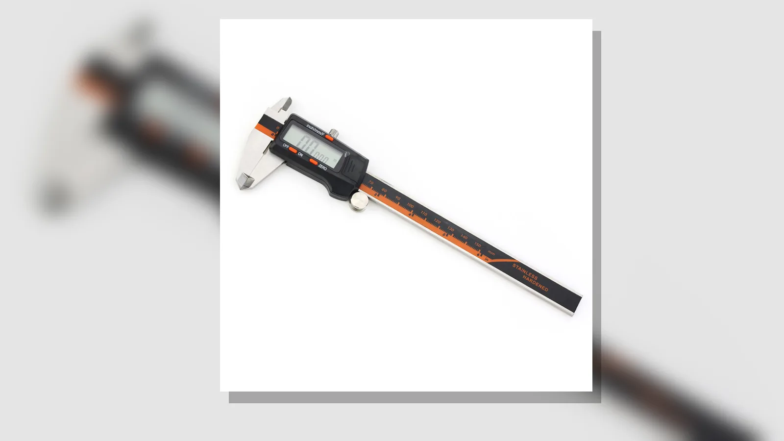 A stainless-steel digital caliper shown on a white background, with the rear step faces visible and seated across two offset surfaces.