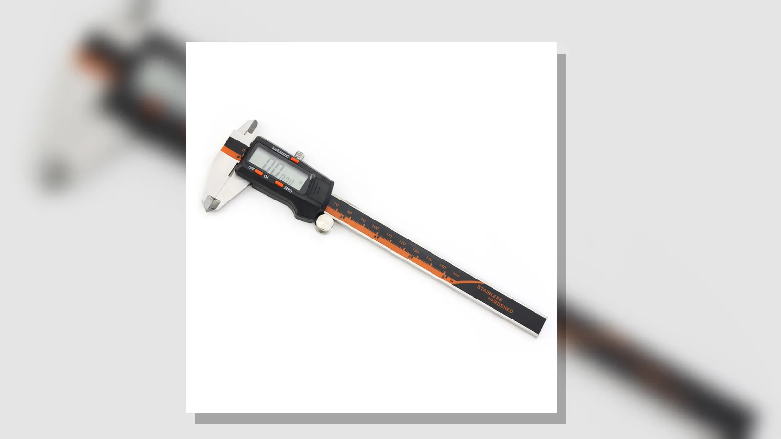 Stainless-steel digital caliper on a white background, with black and orange accents and the jaws slightly open.